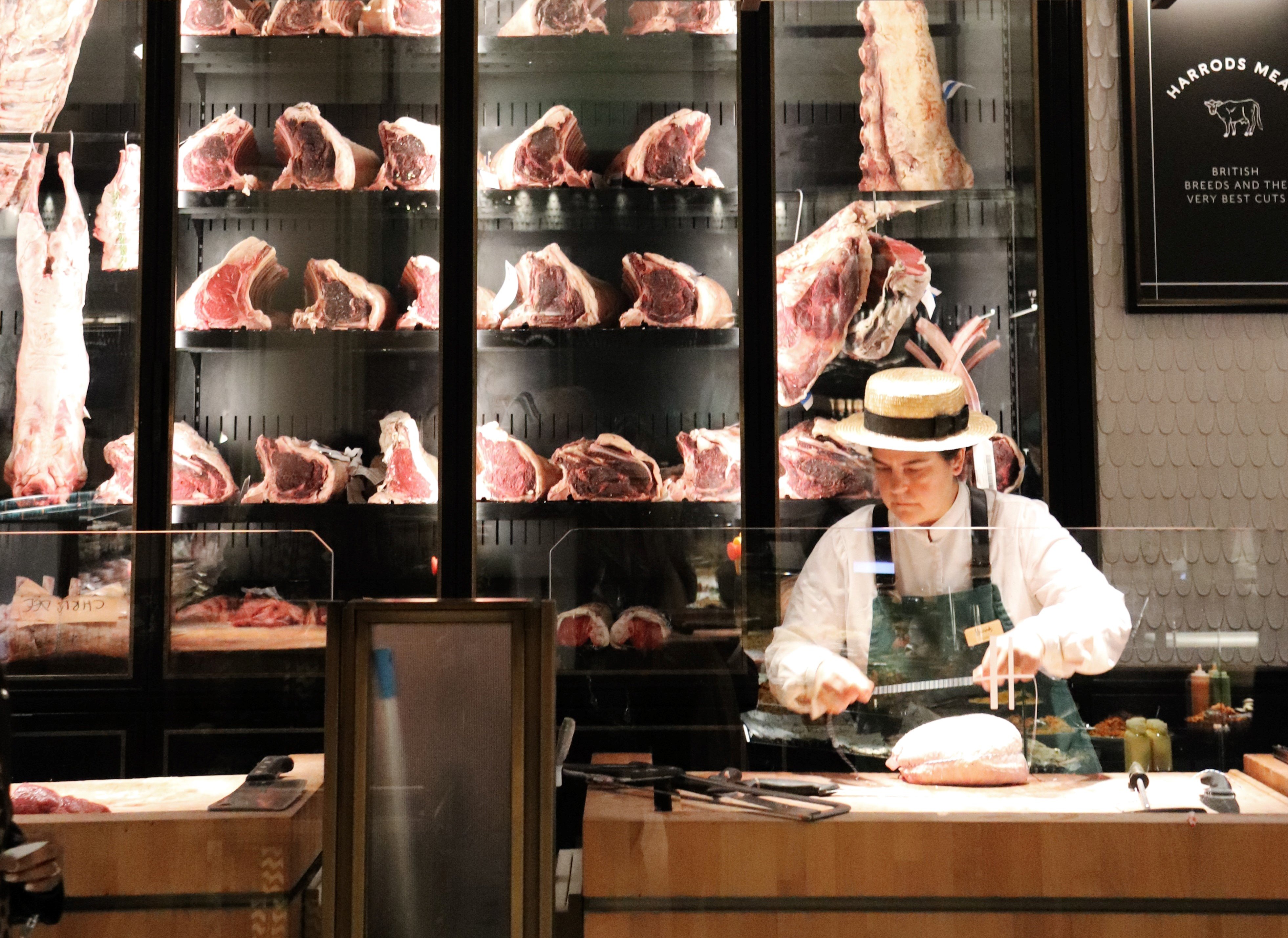 Butcher slicing meat at a local shop