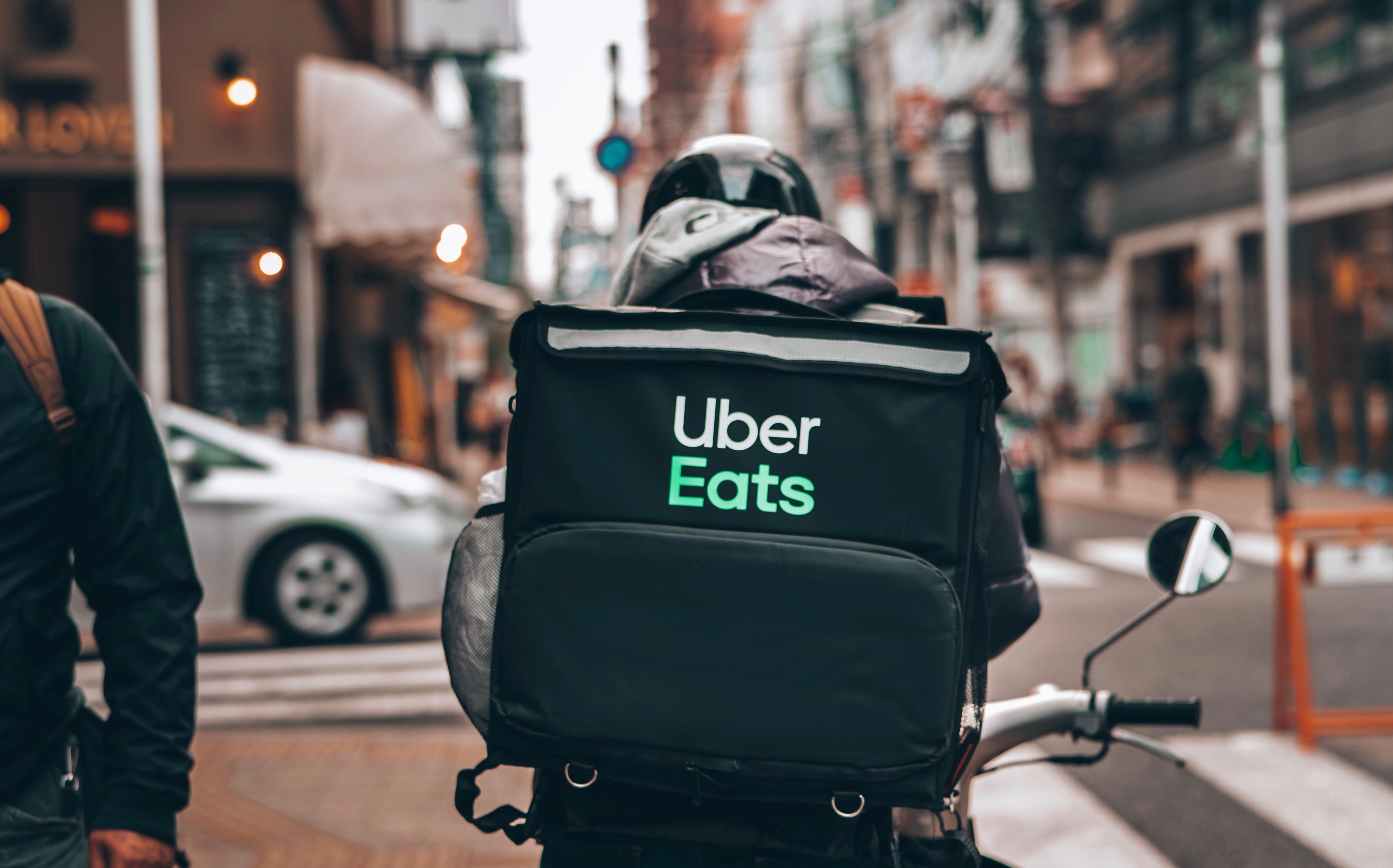 Uber Eats delivery person cycling through the city
