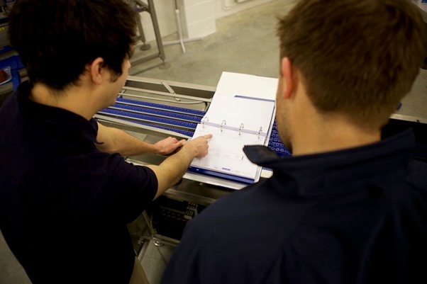 Sealpac UK staff discussing engineering report