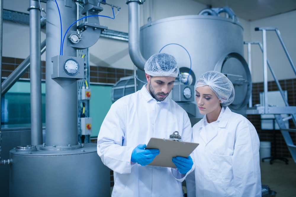 Food technicians working together in a food processing plant-1